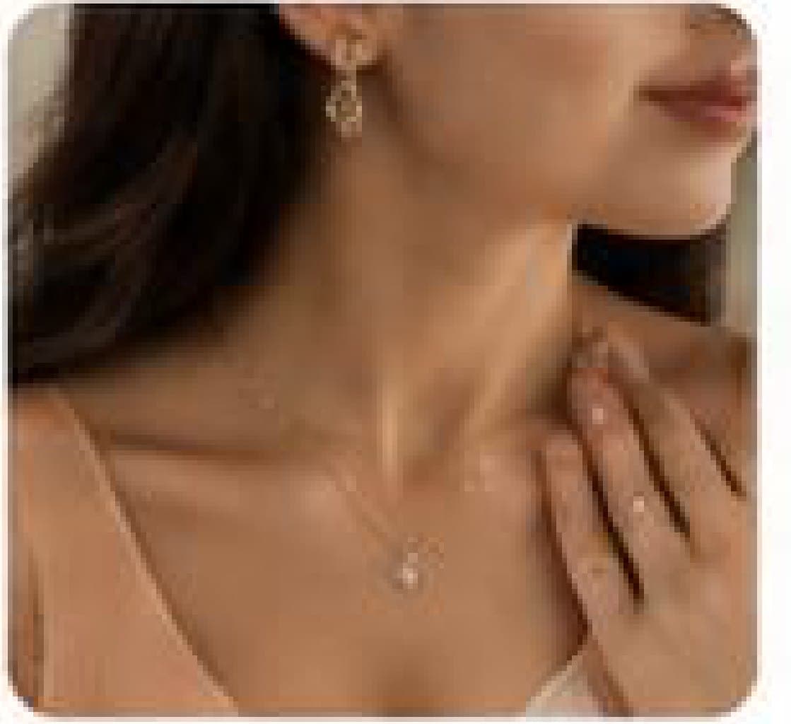 A customer wearing a pendant and drop earrings