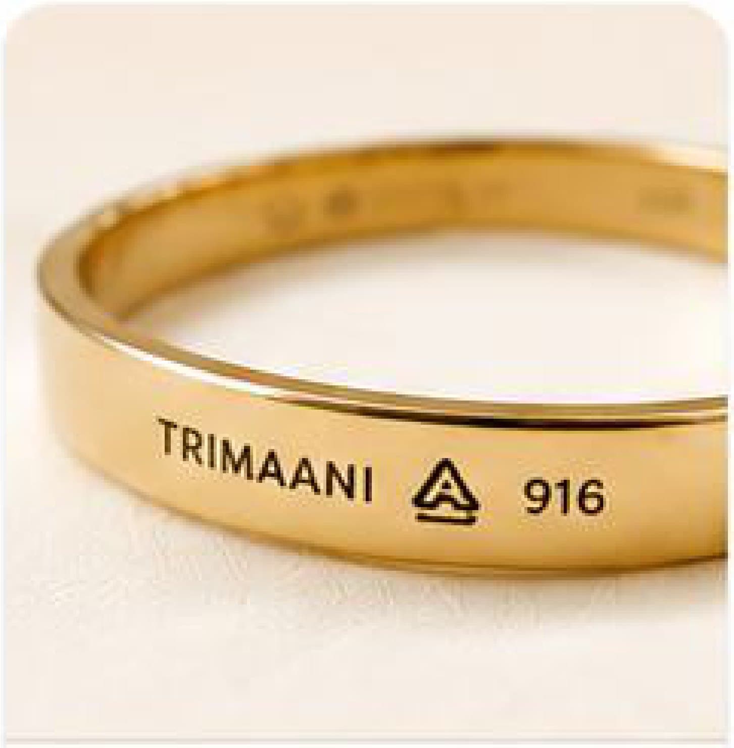 A gold band stamped with the Trimaani mark, the BIS hallmark and 916 purity