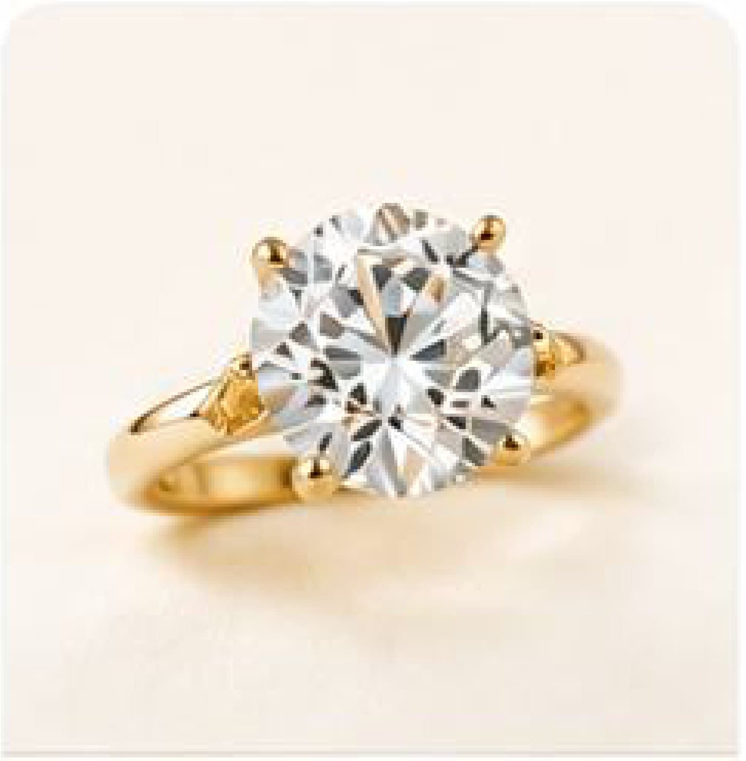 A brilliant-cut solitaire held in a gold six-prong setting