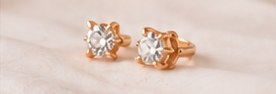 A pair of rose-gold diamond studs freshly set, before final polish
