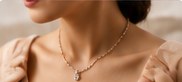 A woman wearing the floral diamond pendant on a fine chain